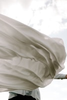 An artistic shot of silk scarves flowing in the wind, highlighting their lightness and elegance.