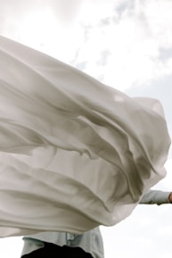Close-up of a flowing floral dress fabric catching the sunlight.