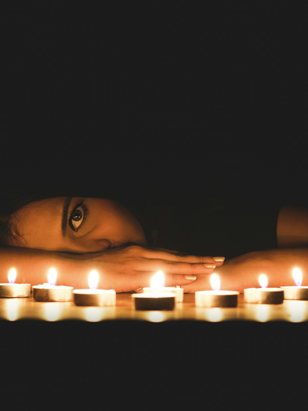 lighted candles on persons face