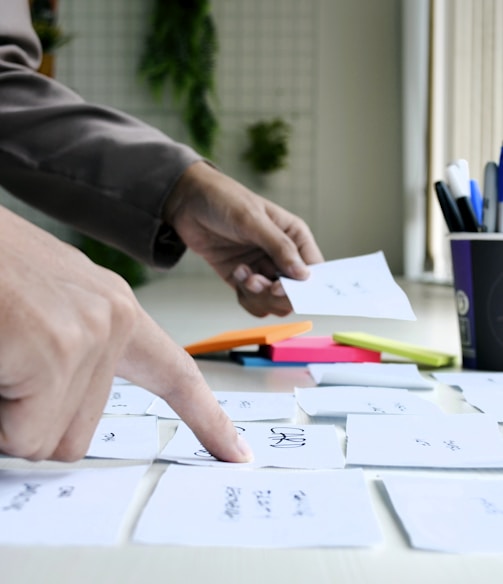 person writing on white paper