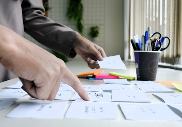 person writing on white paper