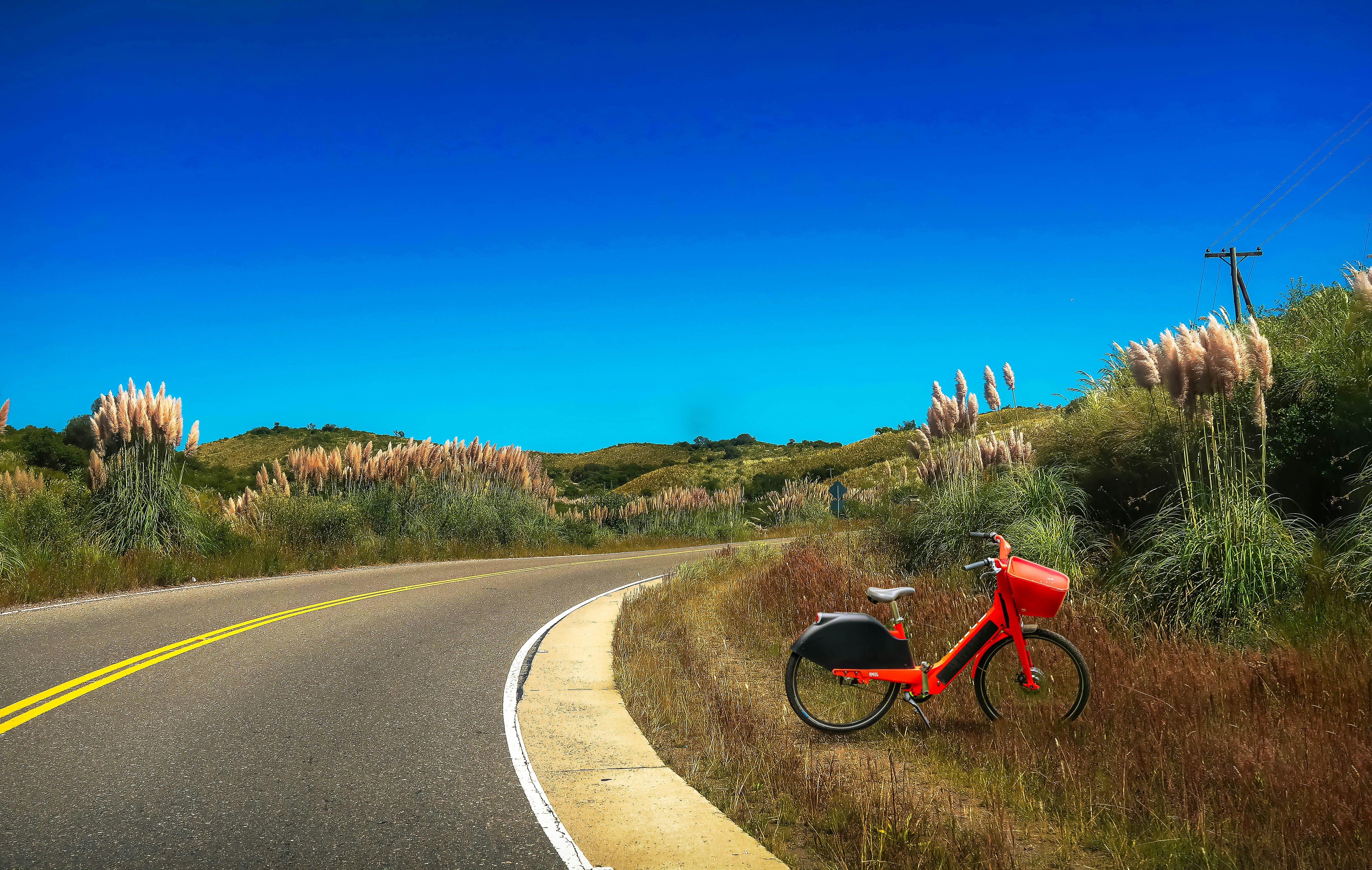 red and black motorcycle on road during daytime