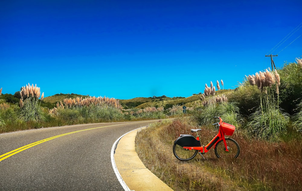 red and black motorcycle on road during daytime