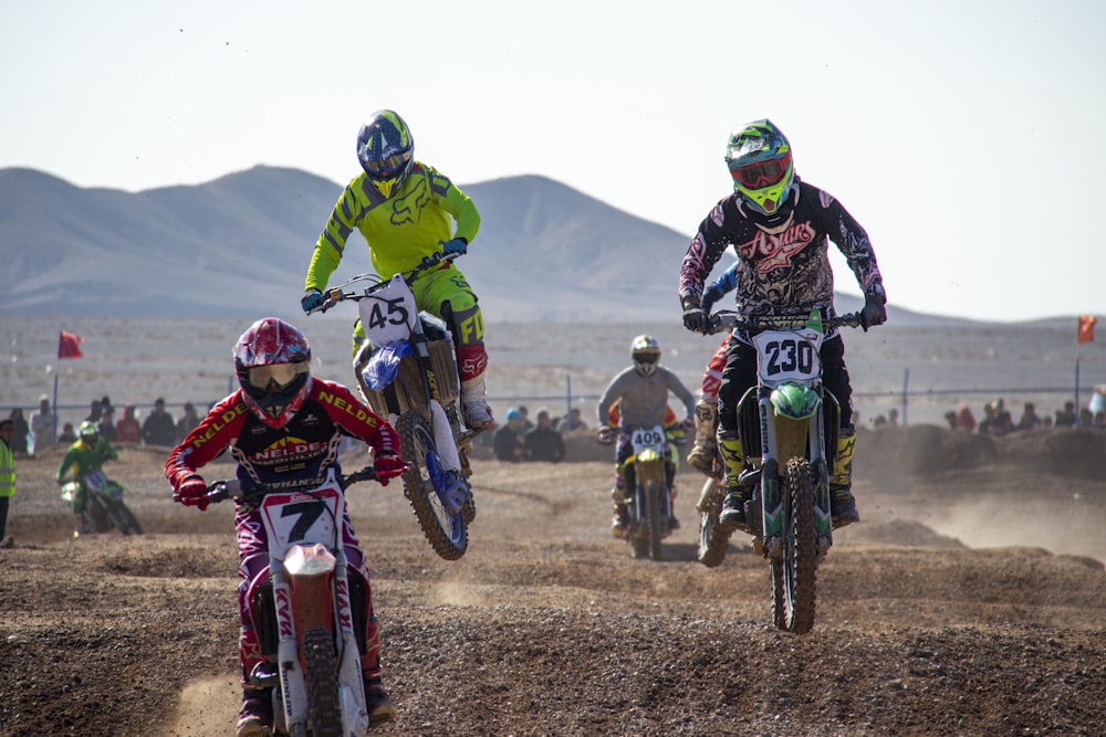 man in green and black motocross suit riding motocross dirt bike