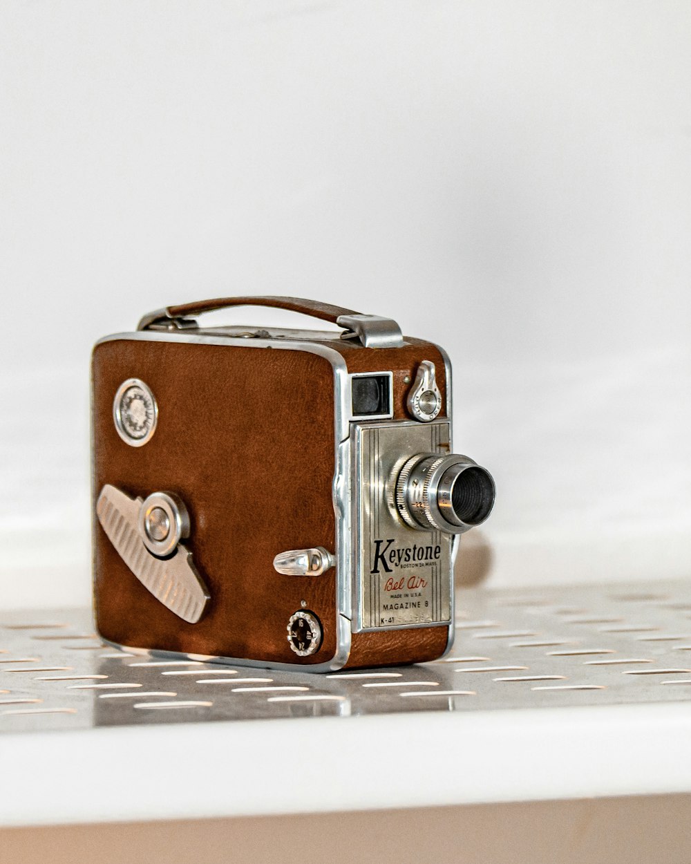 brown and silver camera on white table