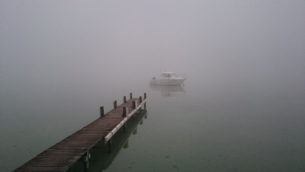 brown wooden dock on body of water