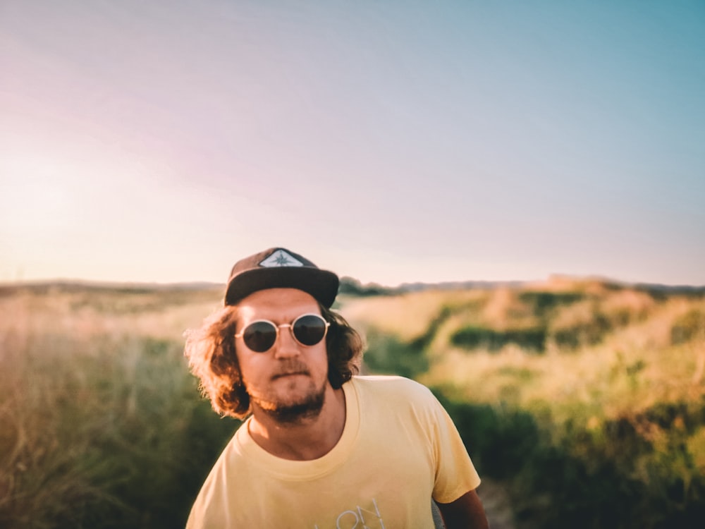 man in white crew neck t-shirt wearing black sunglasses