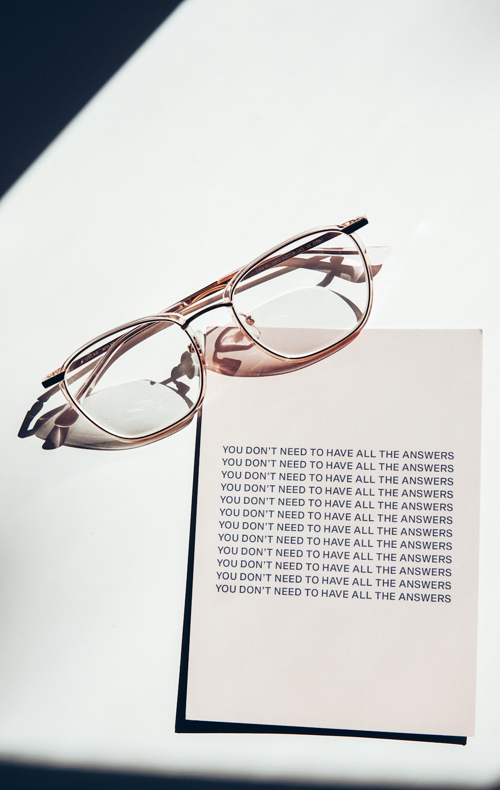 brown framed eyeglasses on white printer paper