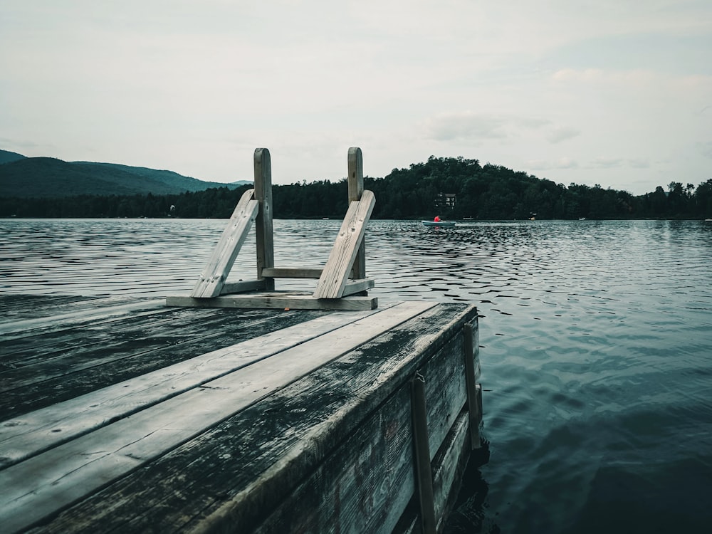 brown wooden dock on body of water during daytime