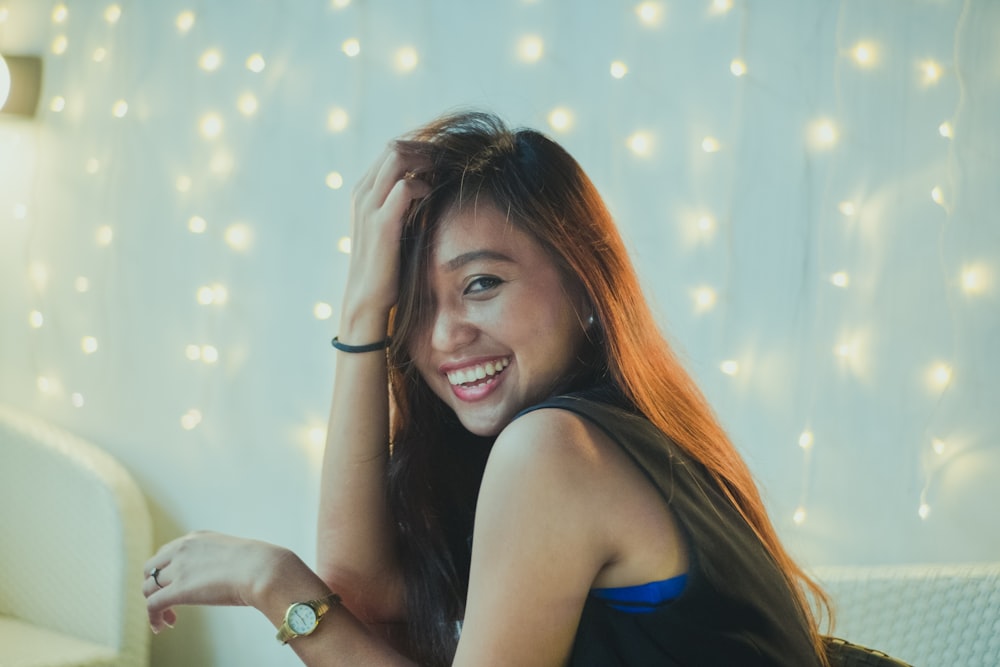 woman in blue tank top smiling