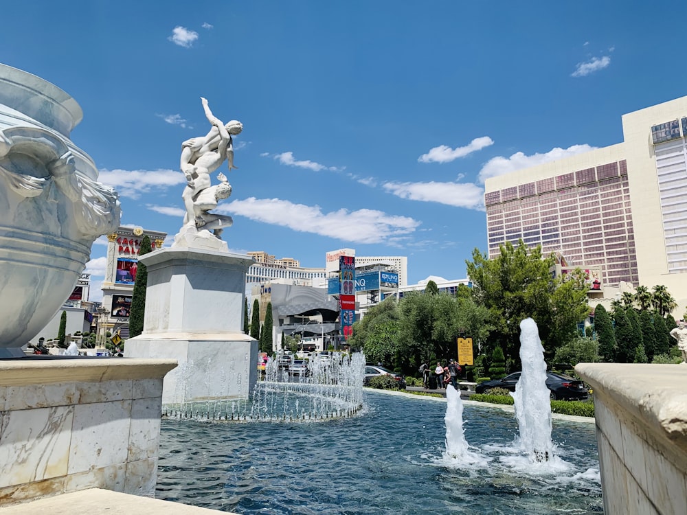 fountain in front of brown building during daytime