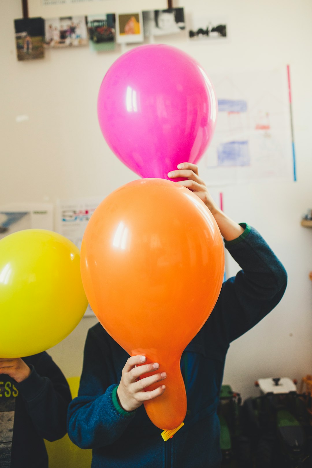 woman holding red yellow and green balloons