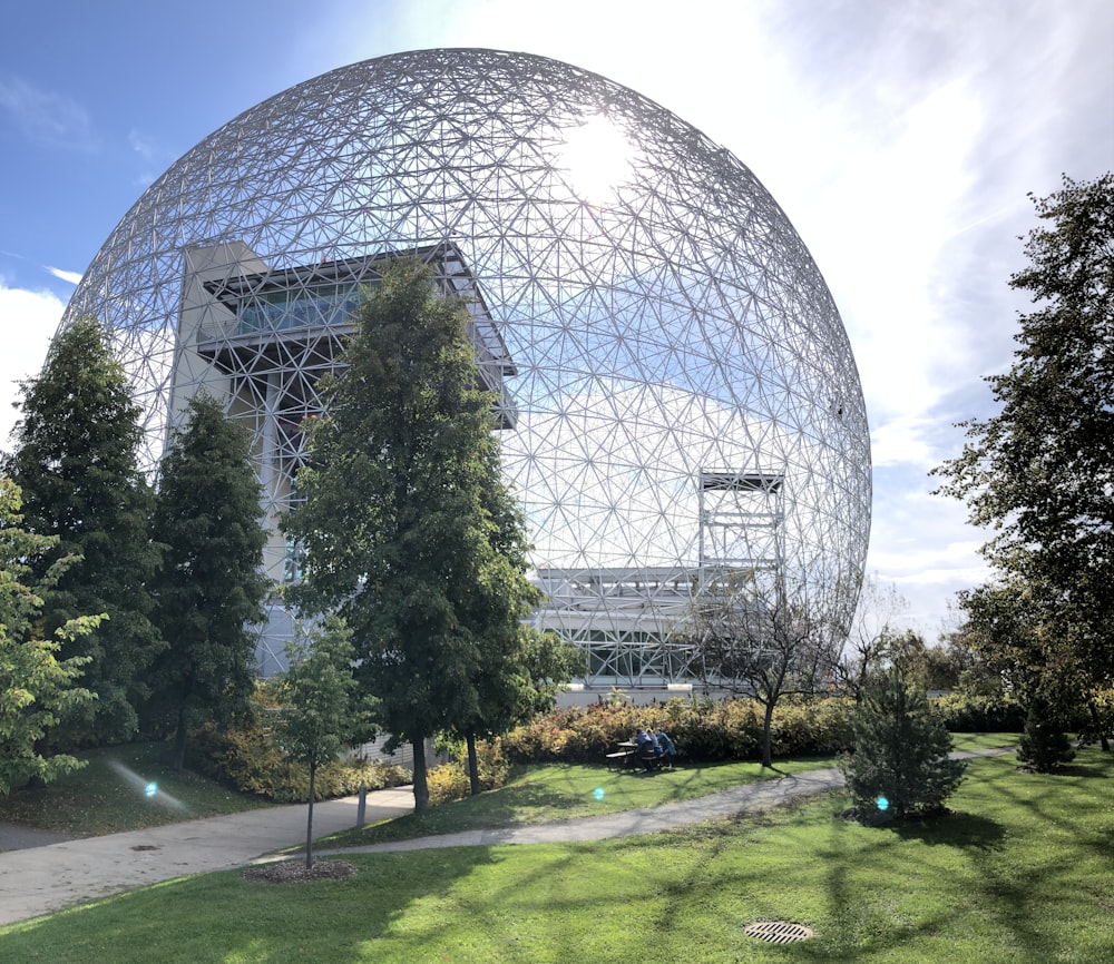 glass building near green trees during daytime