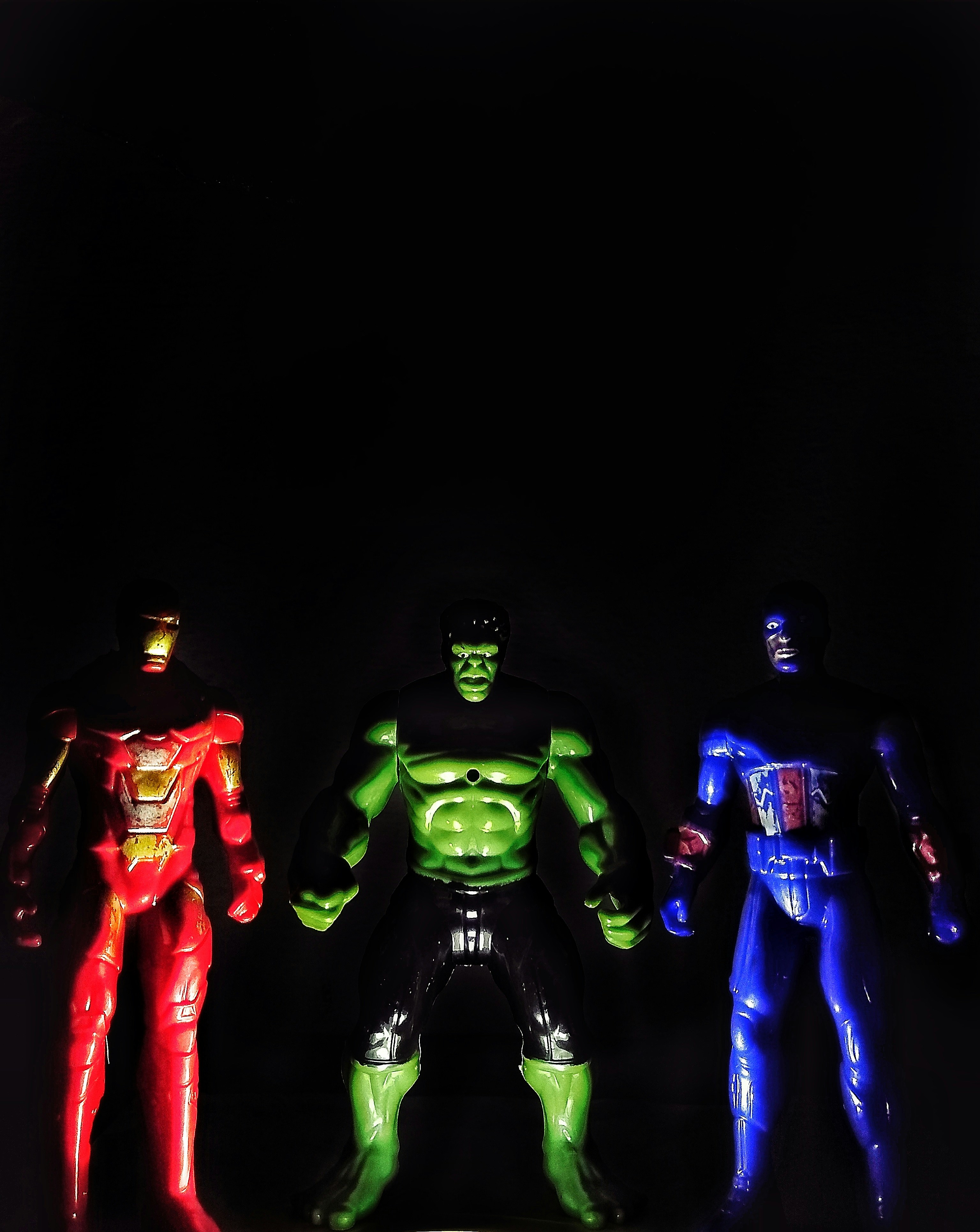 Marvel superhero action figures collection with Iron Man and Captain America in dark atmospheric display