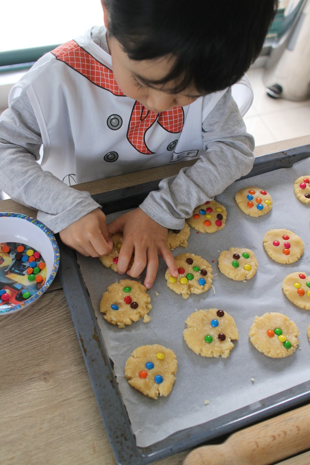 person holding white ceramic plate with cookies