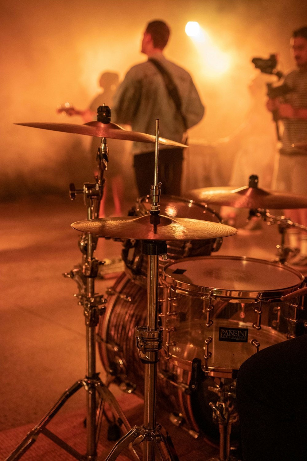 man in black shirt playing drum set