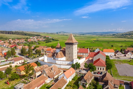 brown and white concrete building under blue sky during daytime in Homorod Romania