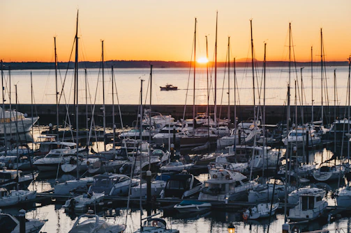 Sunset view over a marina filled with connected yachts and sailboats