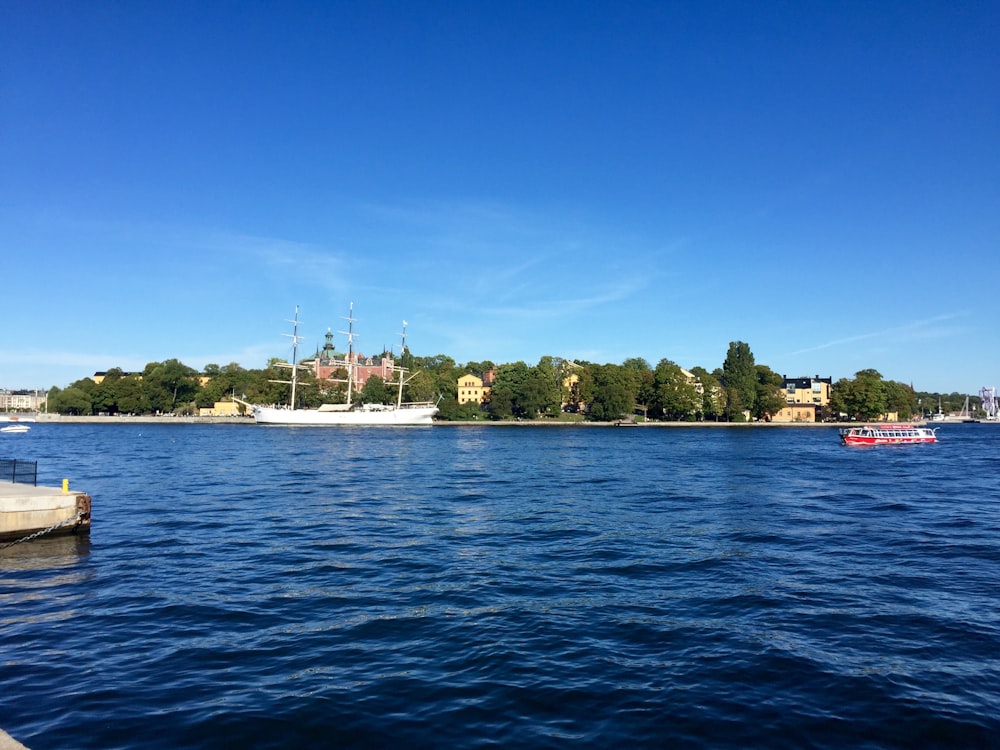 white boat on blue sea under blue sky during daytime