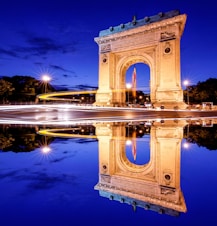 brown concrete arch near body of water during daytime