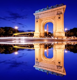brown concrete arch near body of water during daytime