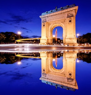 brown concrete arch near body of water during daytime