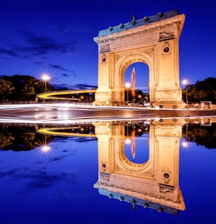 brown concrete arch near body of water during daytime