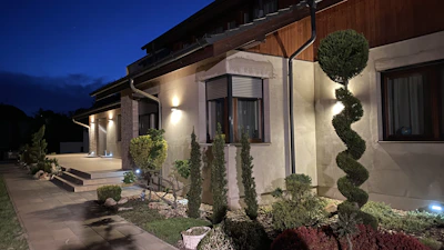A modern home exterior at dusk spotlighting flawless renovation work and elegant design details.