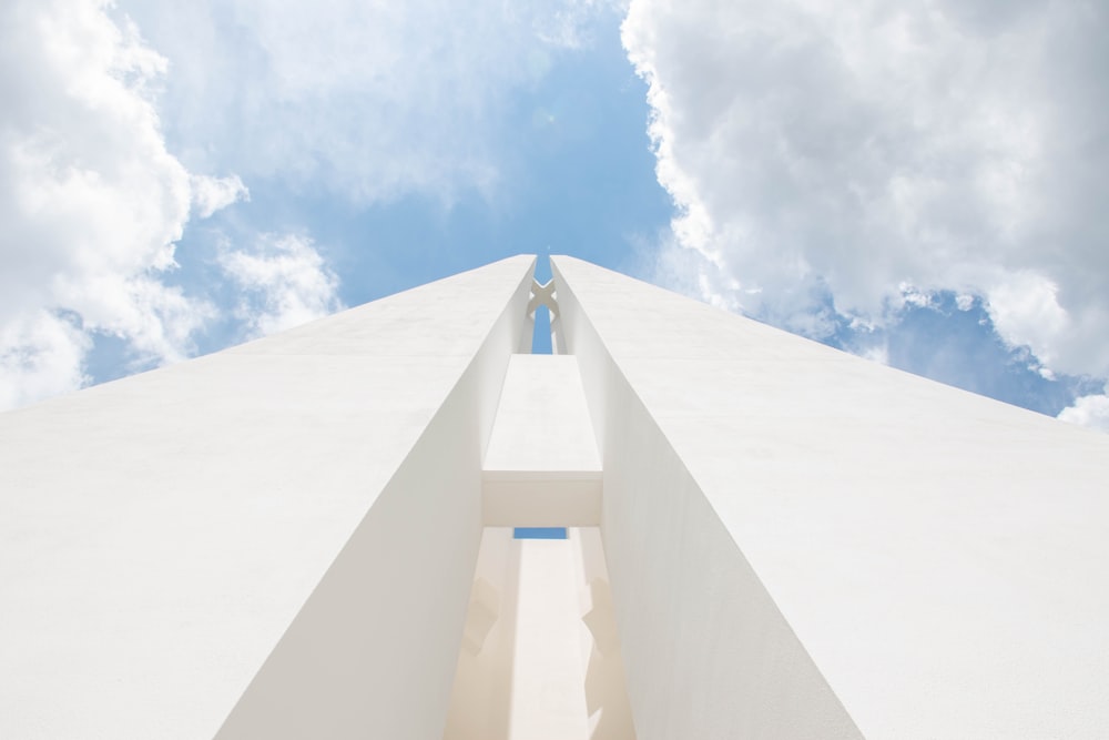 white concrete building under blue sky and white clouds during daytime