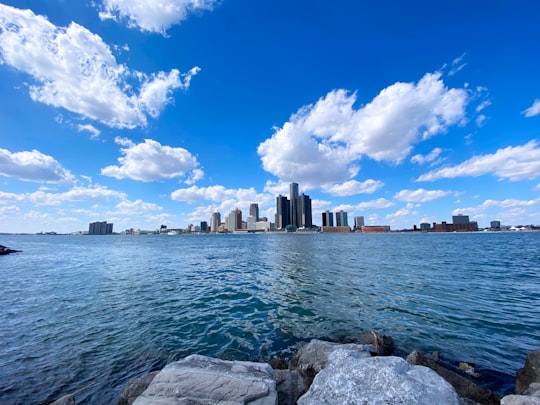 city skyline across body of water under blue and white sunny cloudy sky during daytime in Windsor Canada