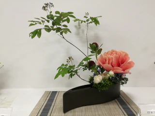 Elegant floral arrangement in a stylish vase, perfect for weddings or events.