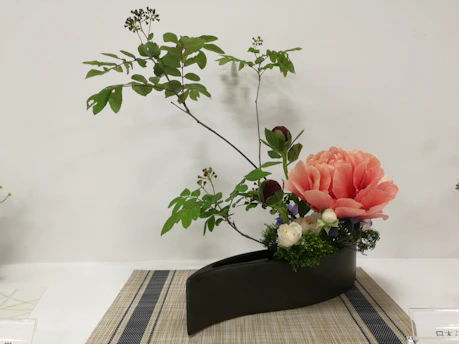 Elegant floral arrangement in a stylish vase, perfect for weddings or events.