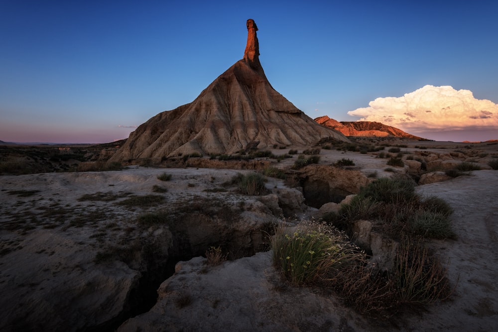 brown rock formation near body of water during daytime