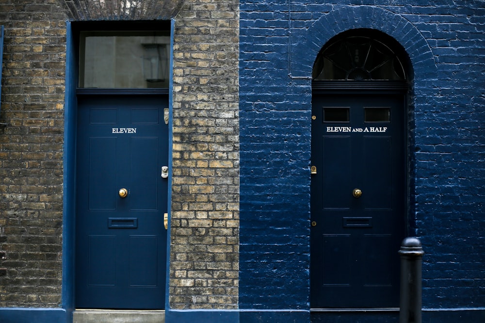 blue wooden door on brown brick building