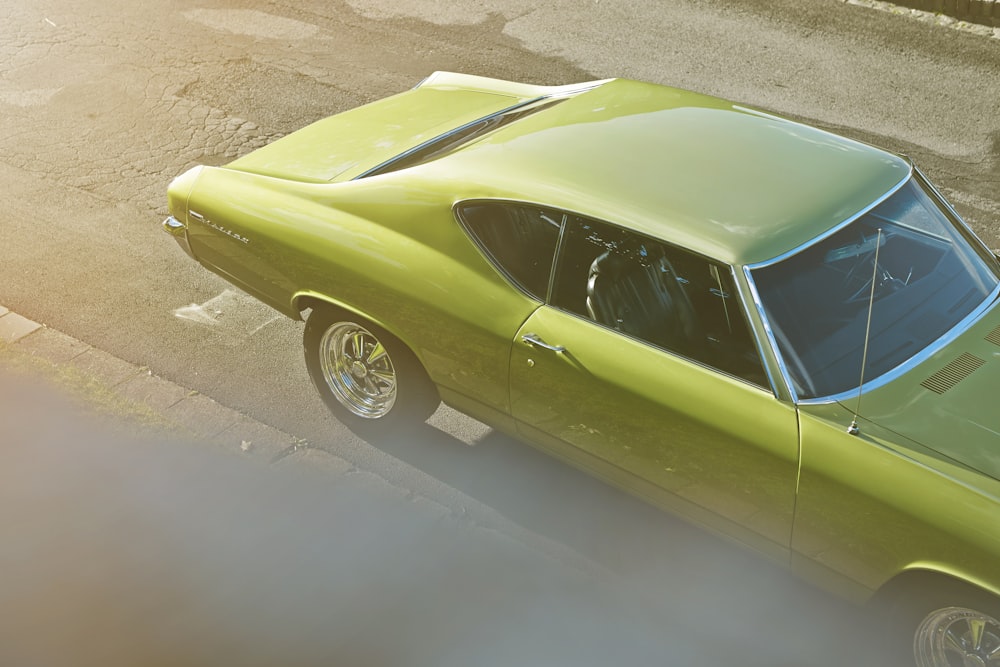 yellow coupe on gray concrete road