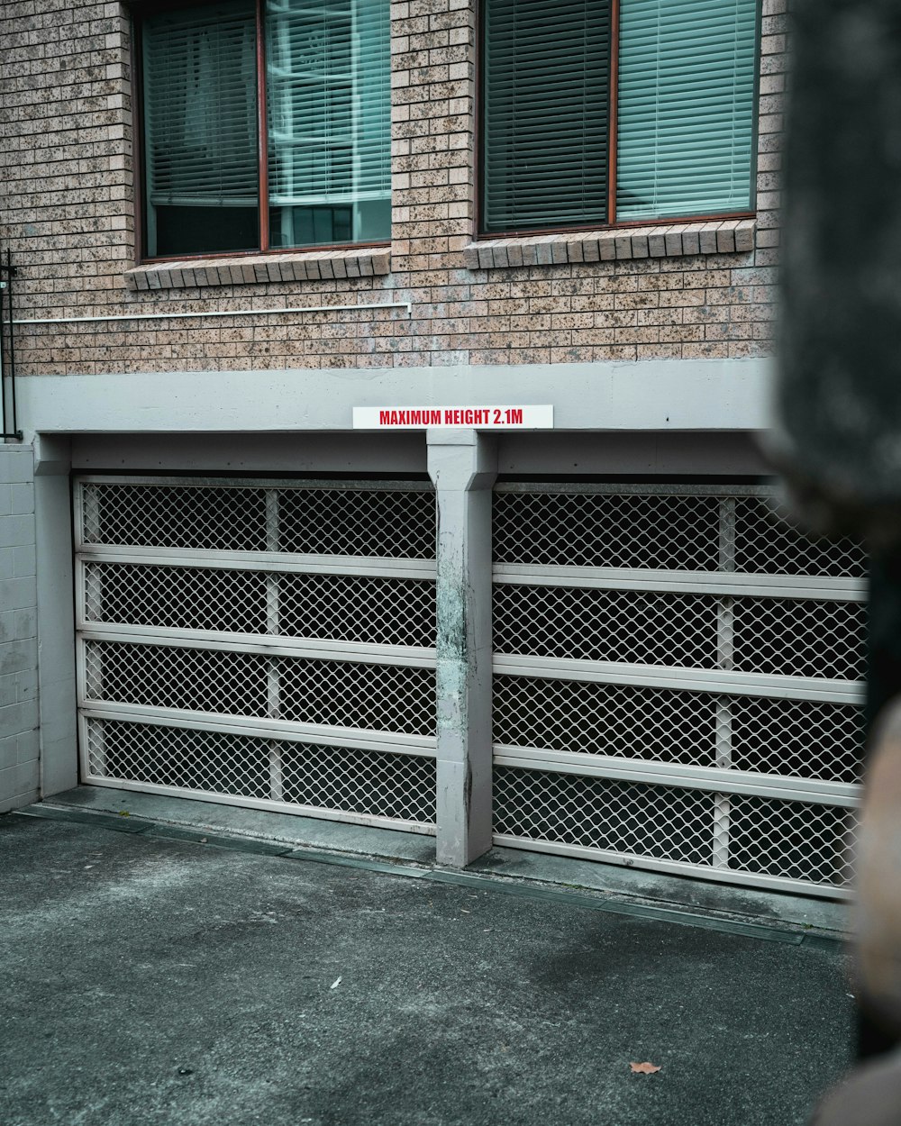 brown brick building with blue steel gate