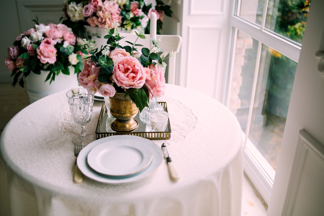 pink roses in clear glass vase on table