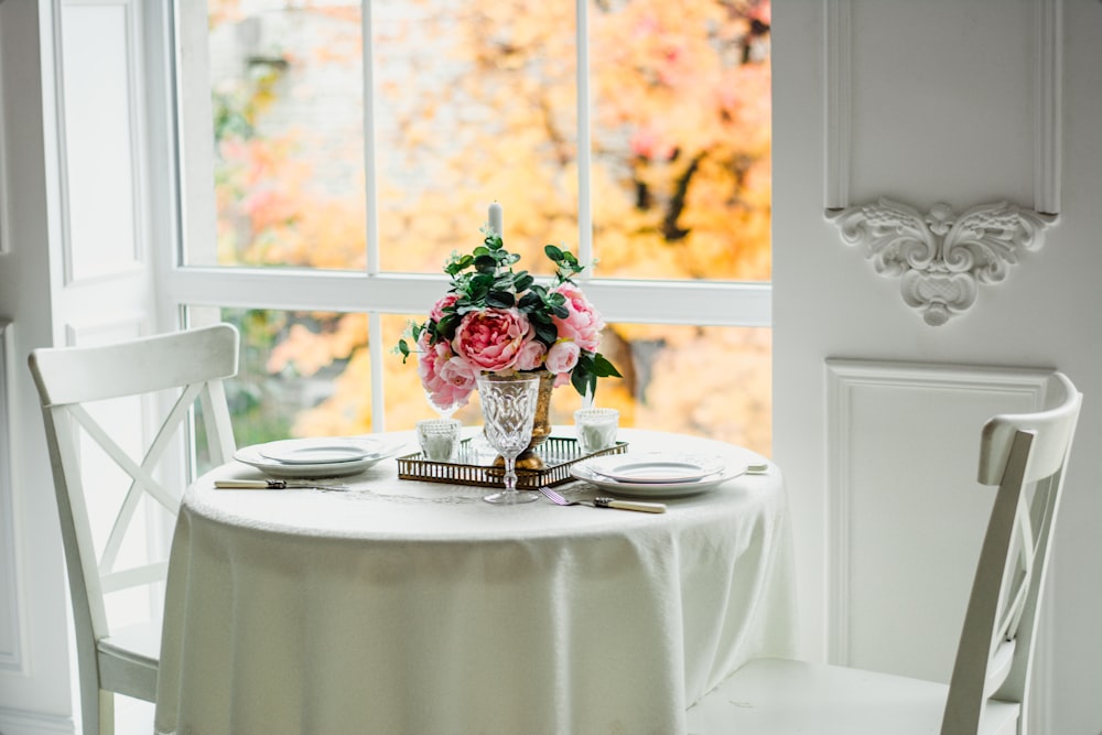 pink roses in clear glass vase on white table