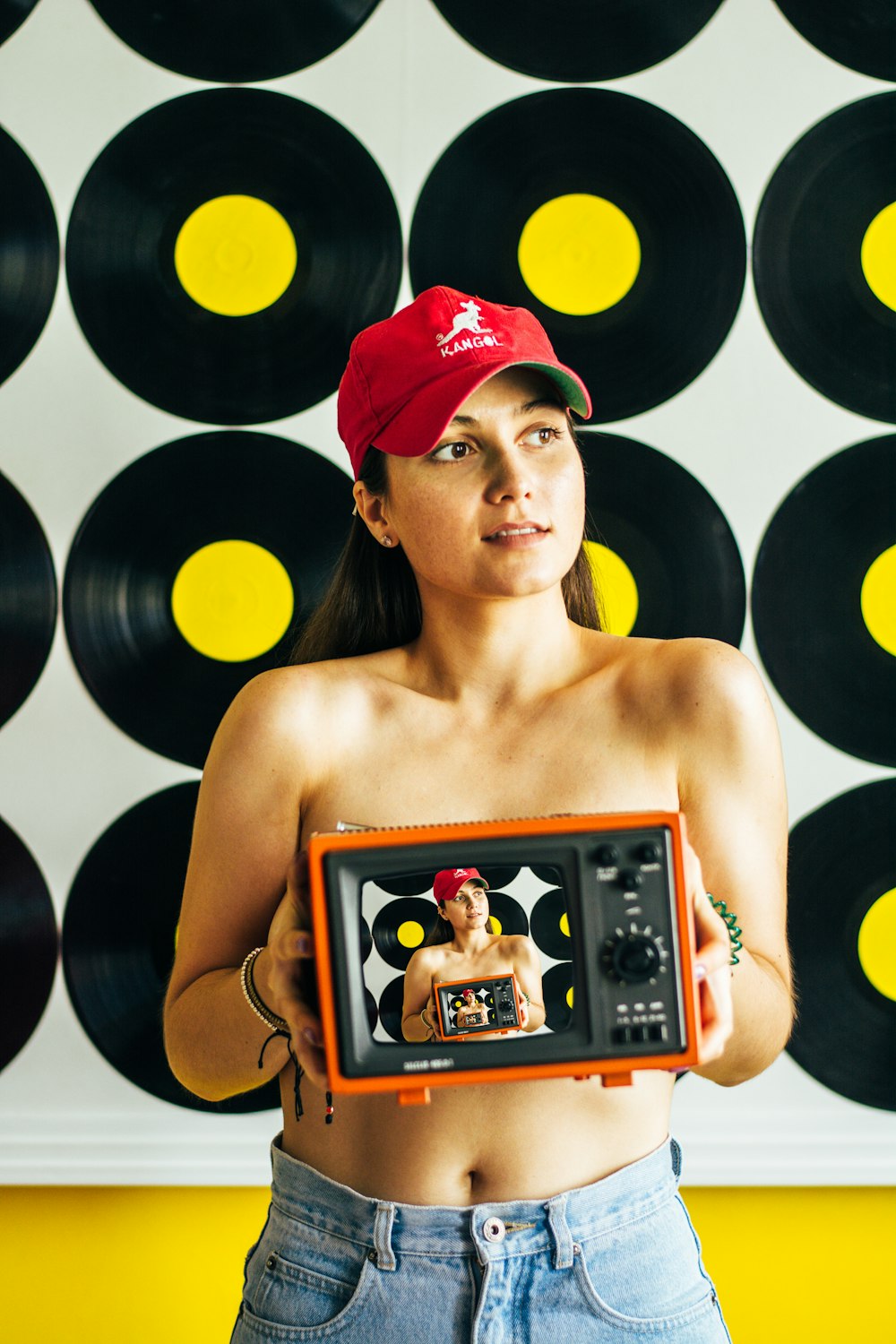 woman in red cap holding brown wooden photo frame