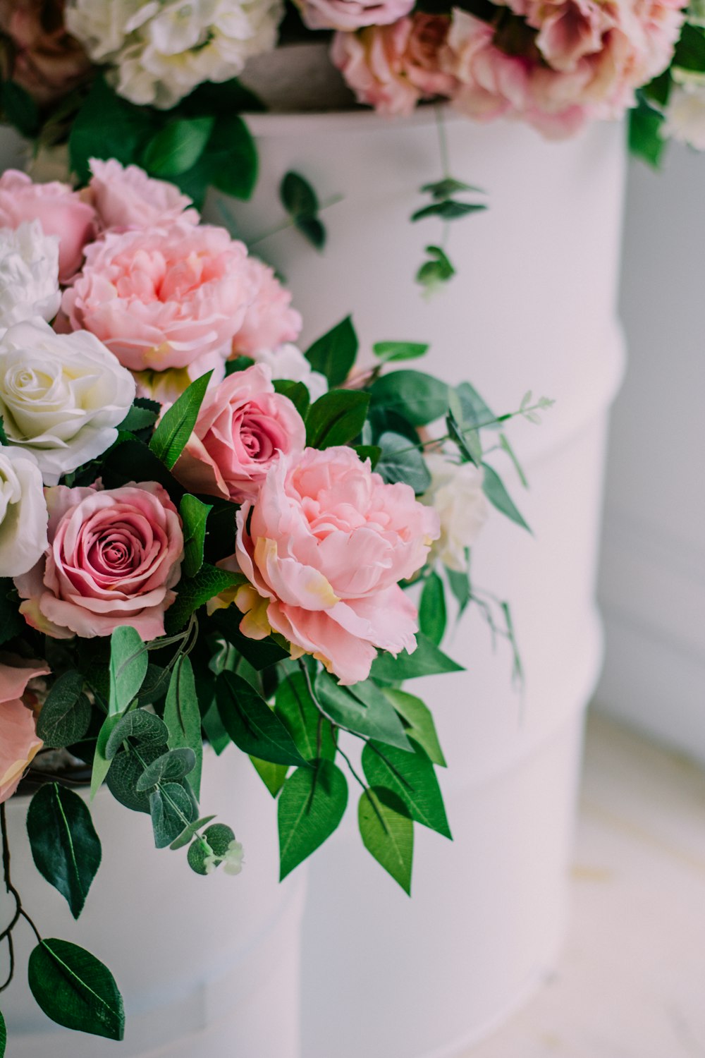 pink roses in white ceramic vase