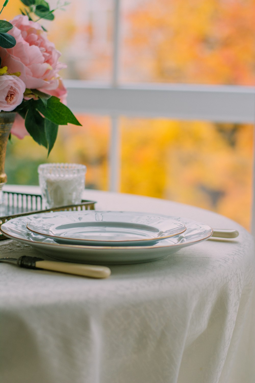 pink rose on white ceramic round plate