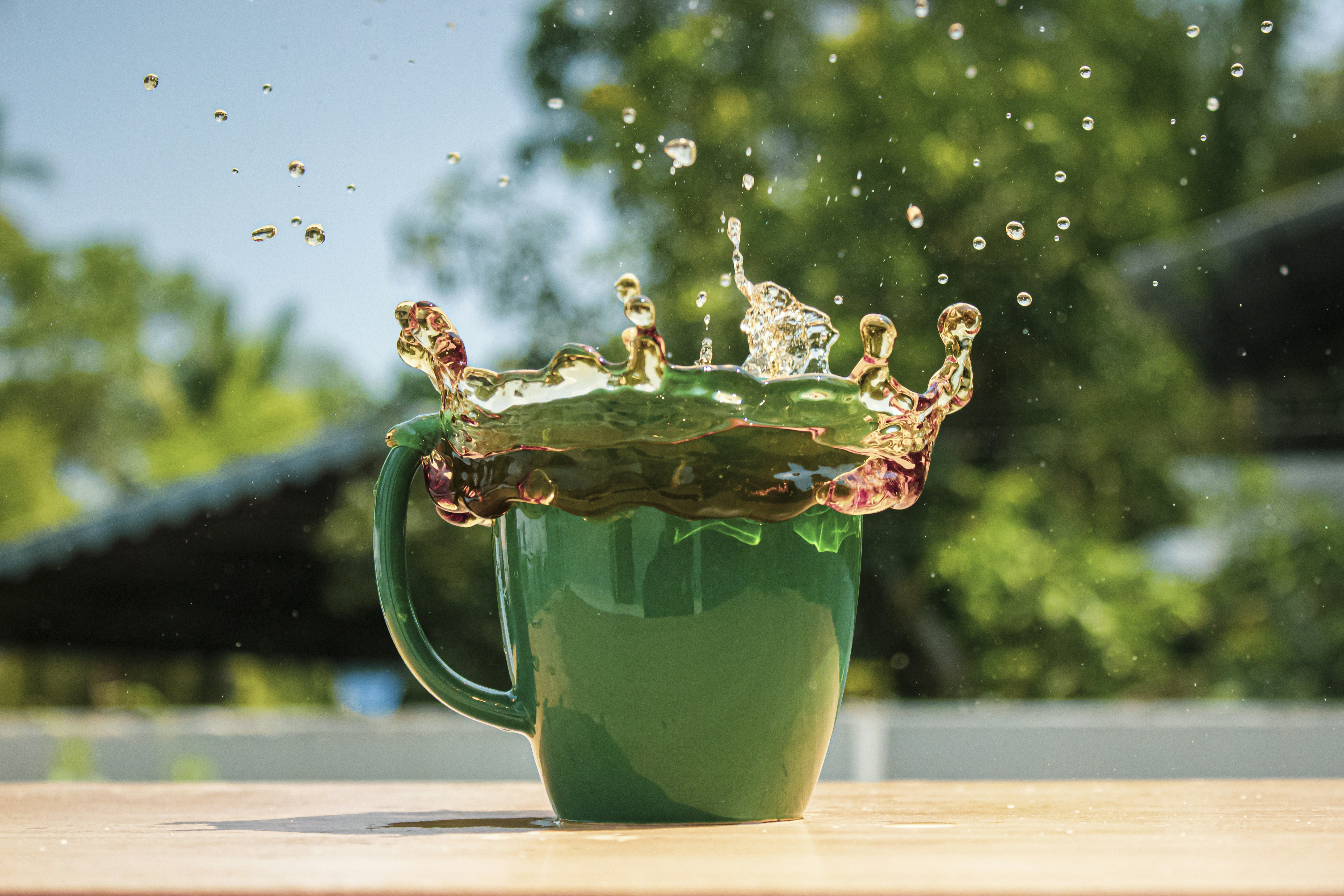 green ceramic mug with water