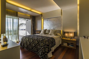 A luxurious bedsheet set in deep black with subtle gold accents, elegantly draped on a modern bed.