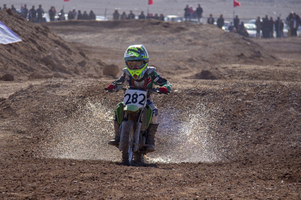 man in green and yellow motocross suit riding motocross dirt bike