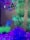 A colorful aquarium filled with vibrant fish and lush artificial plants. The tank is adorned with various vivid hues of blue, green, and magenta, with fish swimming among the foliage. The tank's substrate is covered with bright pink and purple pebbles, enhancing the neon aesthetic.