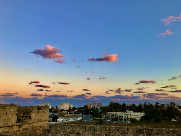 Sunset over a colonial Mexican city with historic architecture and pink skies.