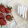 Close-up of a rustic wooden board with slices of creamy menonita cheese and fresh herbs.