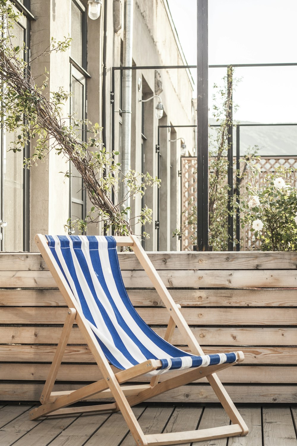 blue and white striped chair near tree