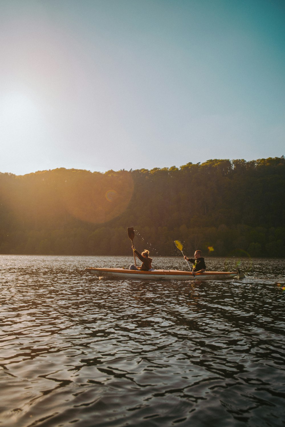 2 person riding on brown boat on body of water during daytime