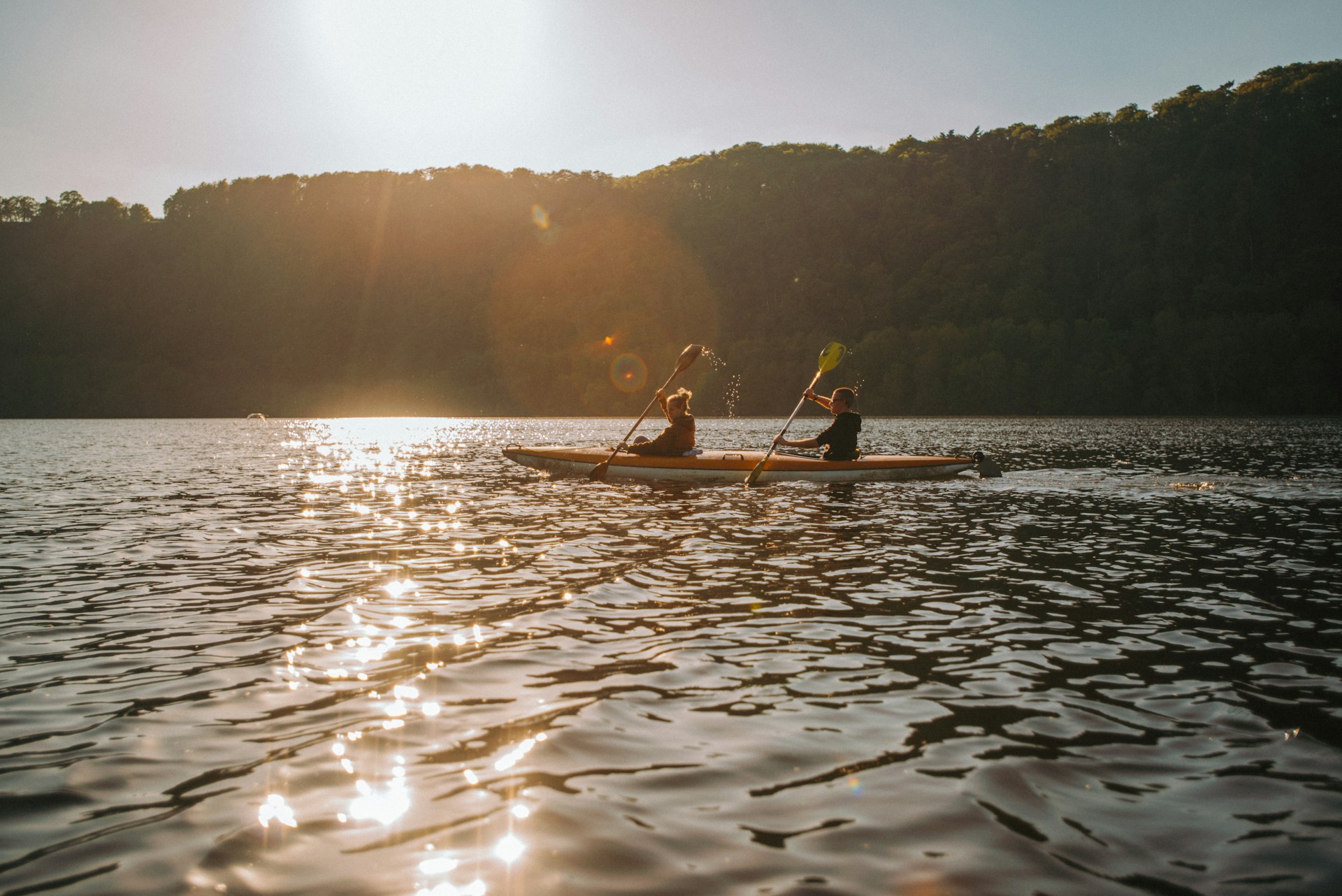 man in yellow shirt riding on boat during daytime